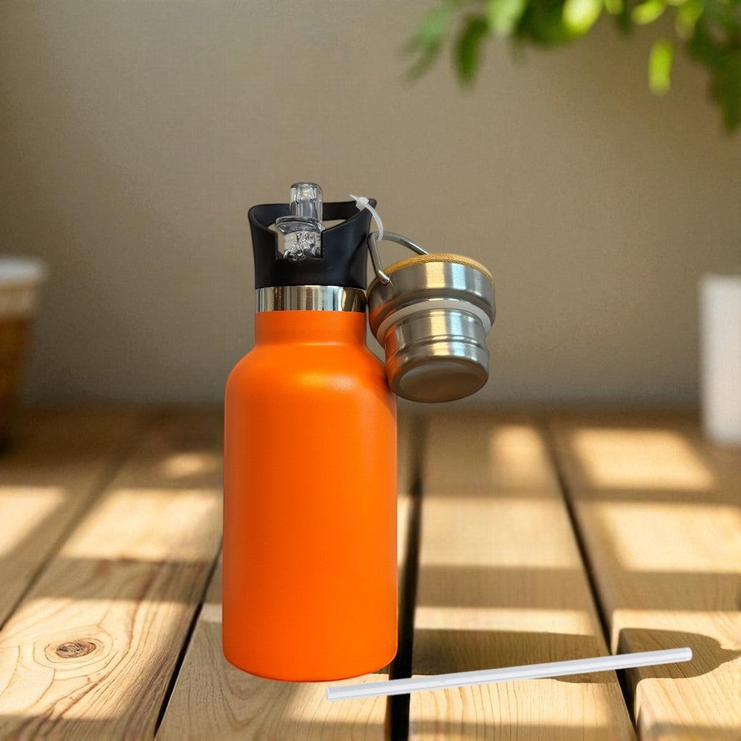 Nomafu 350ml orange stainless steel insulated water bottle with sport lid and straw on a wooden surface