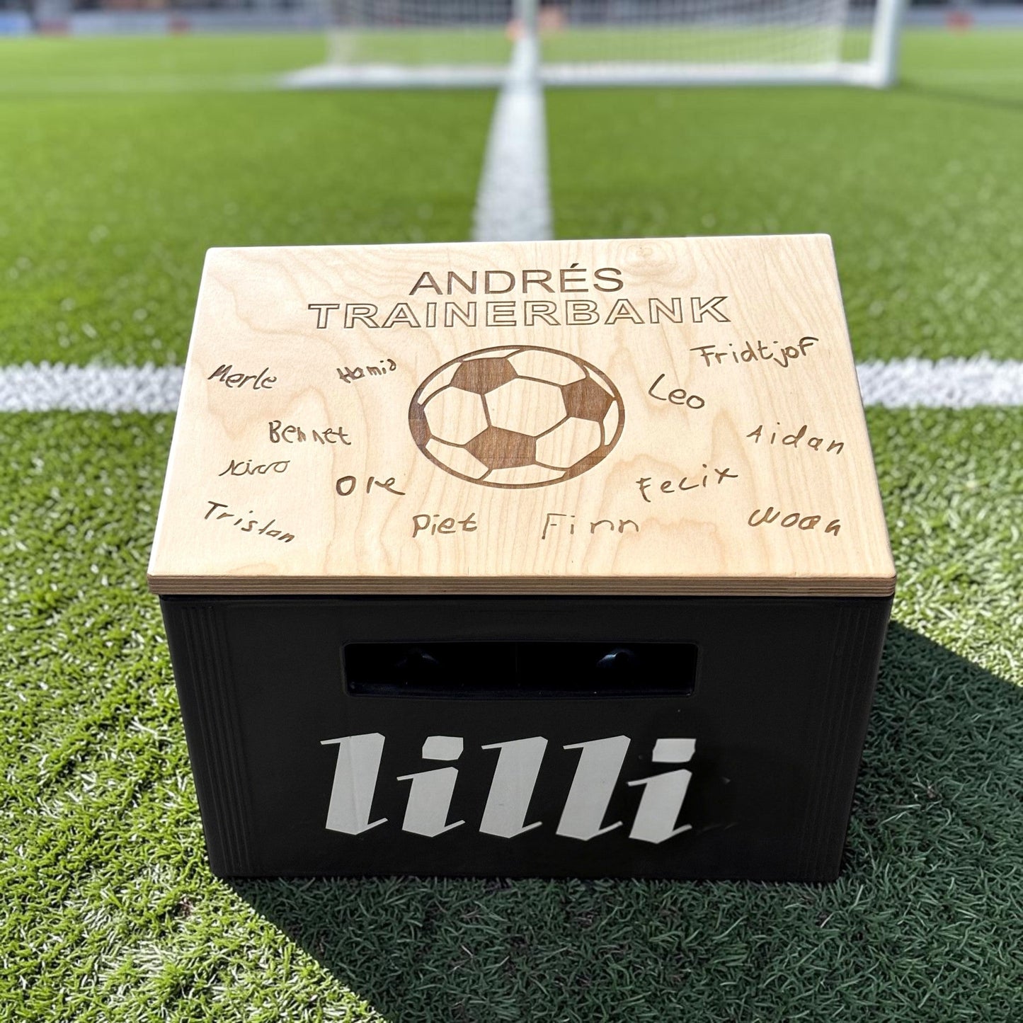 Nomafu wooden crate seat topper with custom laser-engraved soccer design and names, placed on a black beverage crate.