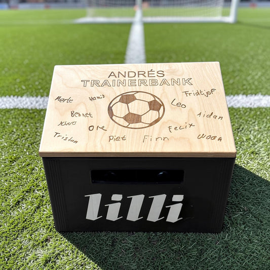 Nomafu wooden crate seat topper with custom laser-engraved soccer design and names, placed on a black beverage crate.